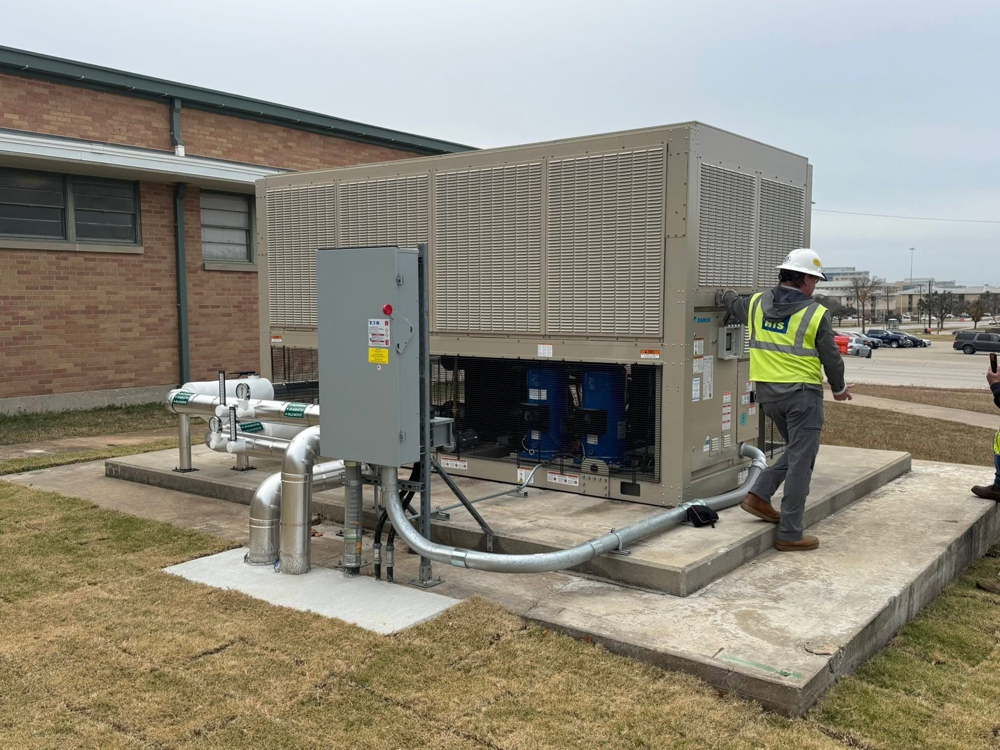 Technician inspecting controls during a planned maintenance visit