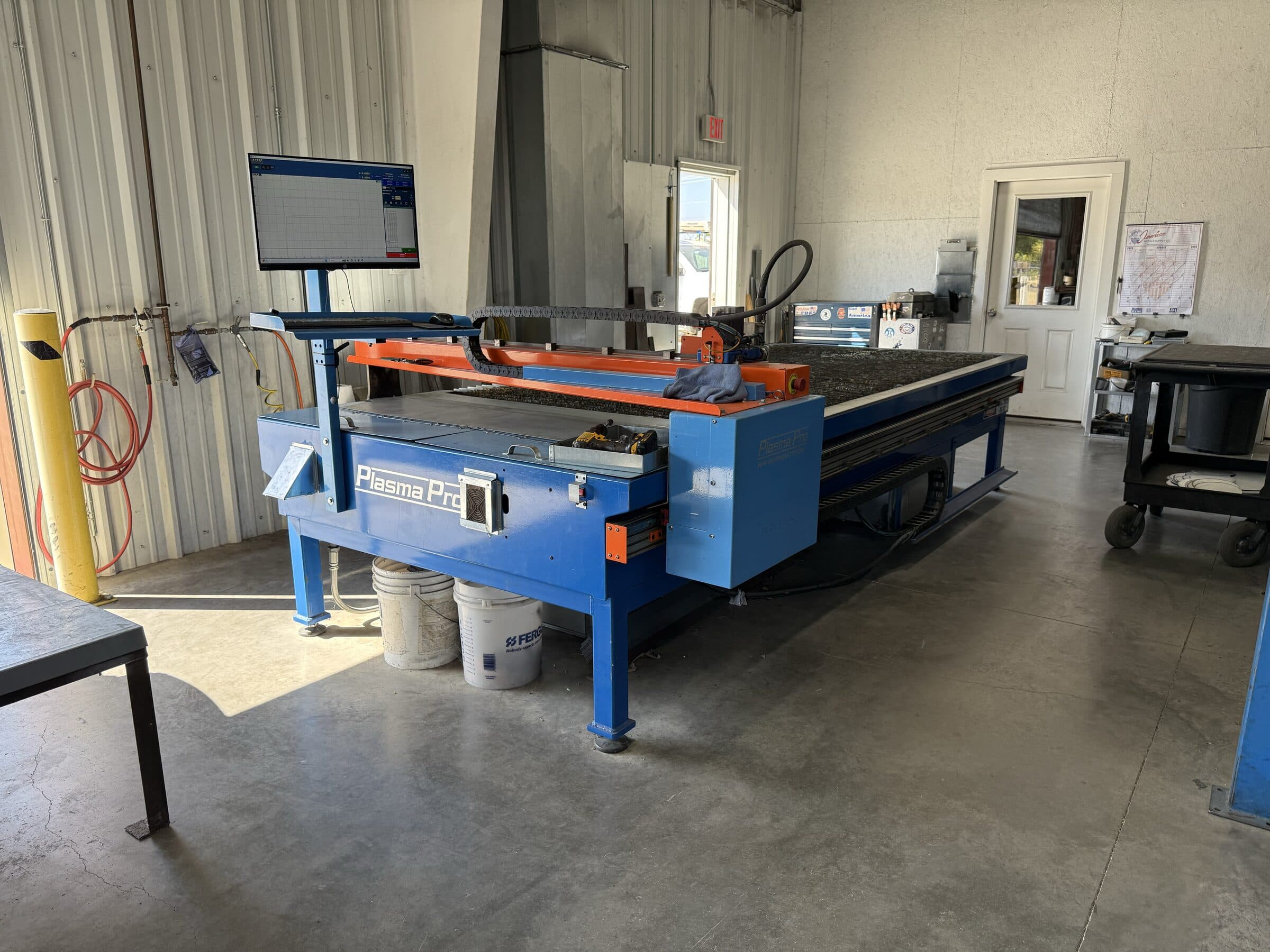 CNC plasma cutting workspace inside Seneca Mechanical's fabrication shop
