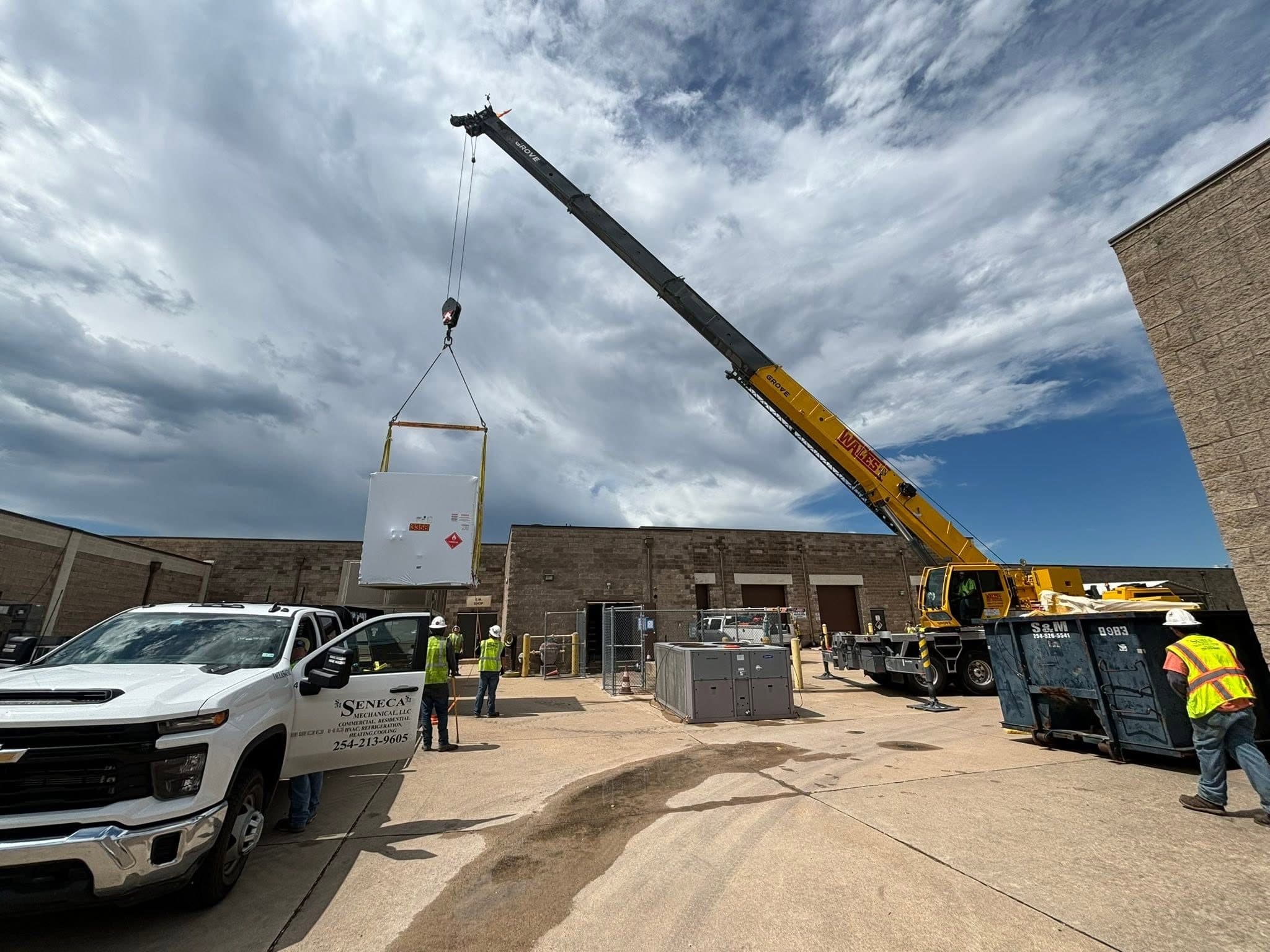 Commercial mechanical equipment being installed during a crane set